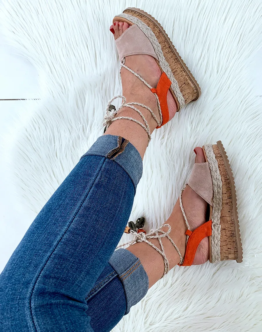 Beige suede wedge espadrilles with rope lace-up ankle tie and pom-pom.