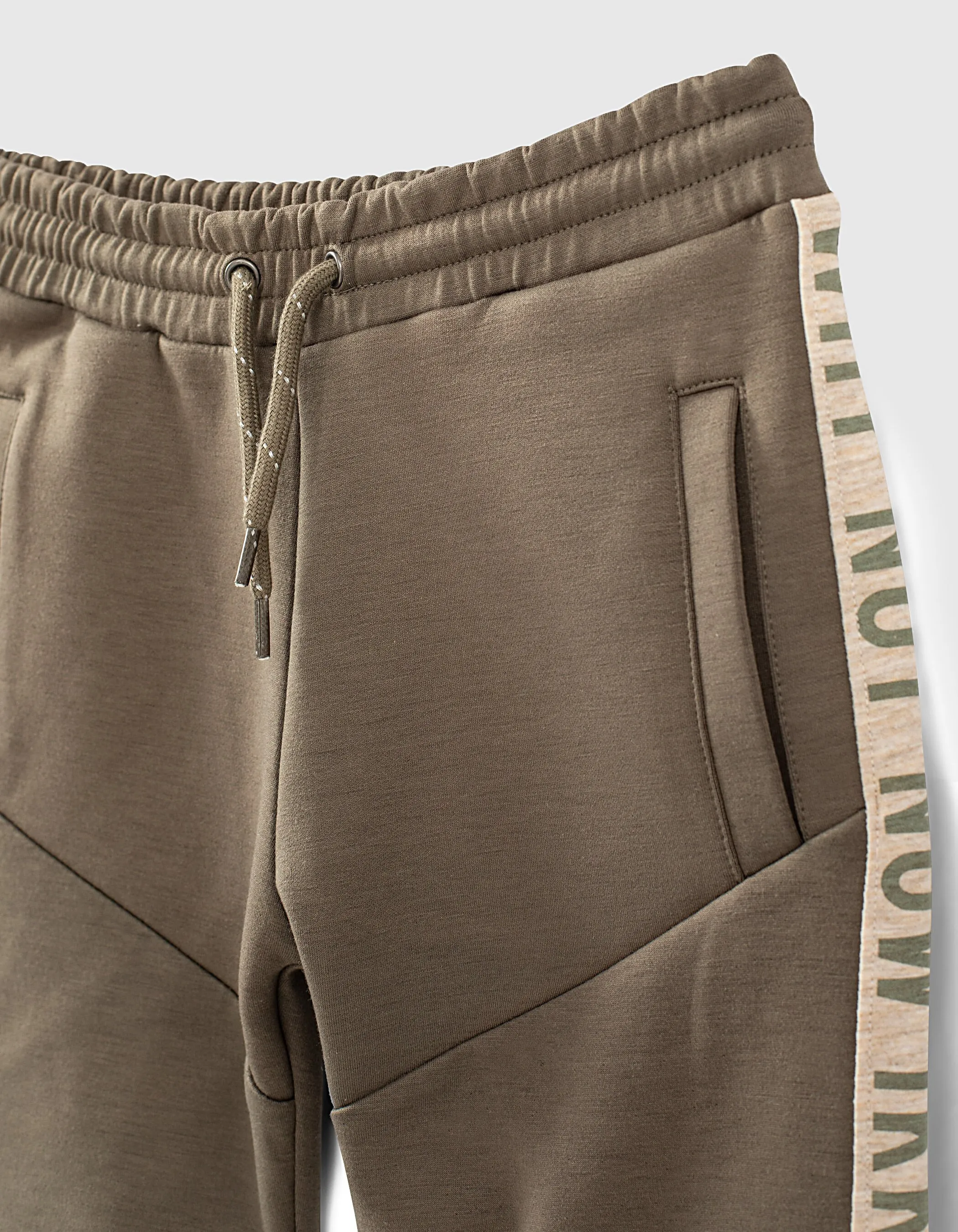 Dark khaki Bermuda shorts with boy sides typography.
