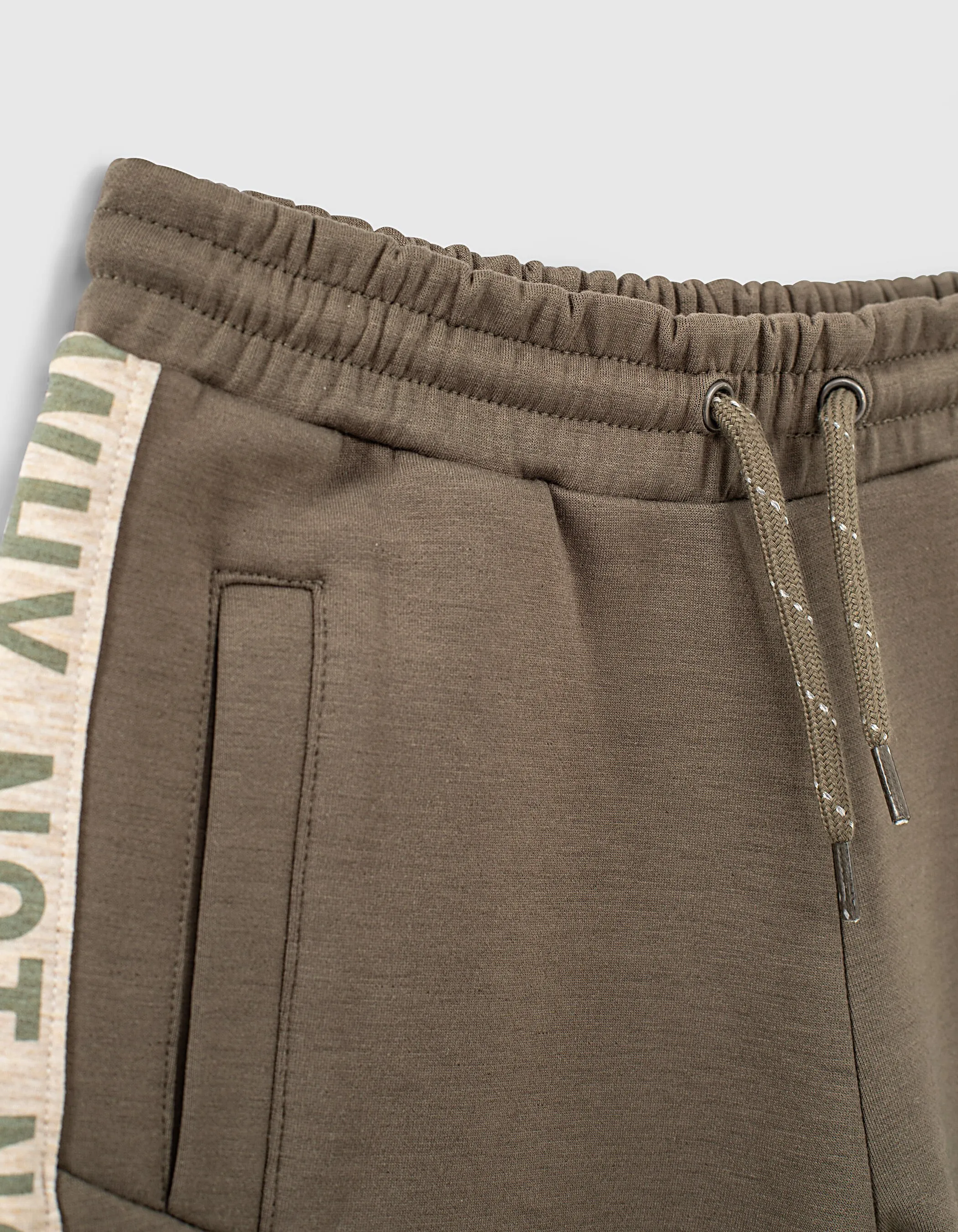 Dark khaki Bermuda shorts with boy sides typography.