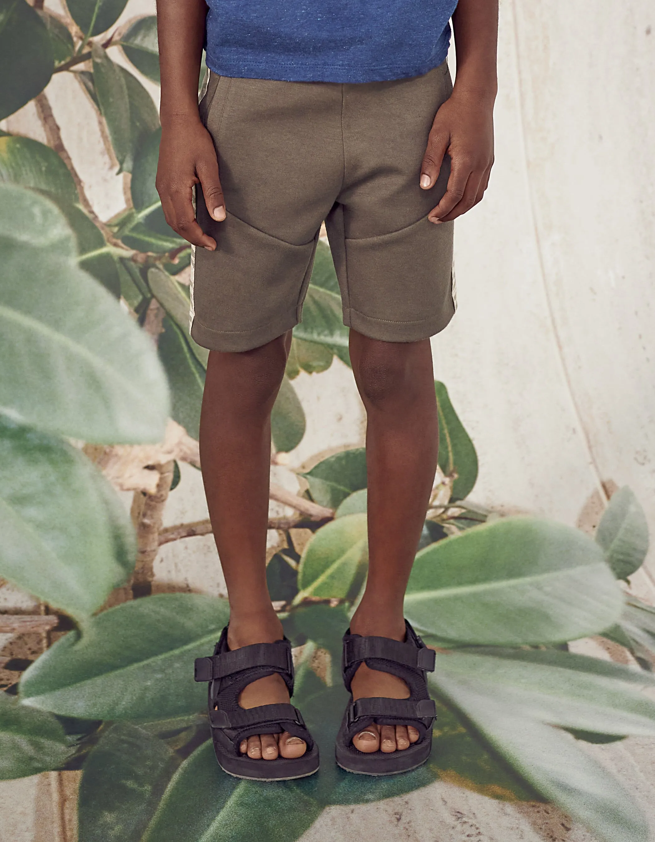 Dark khaki Bermuda shorts with boy sides typography.