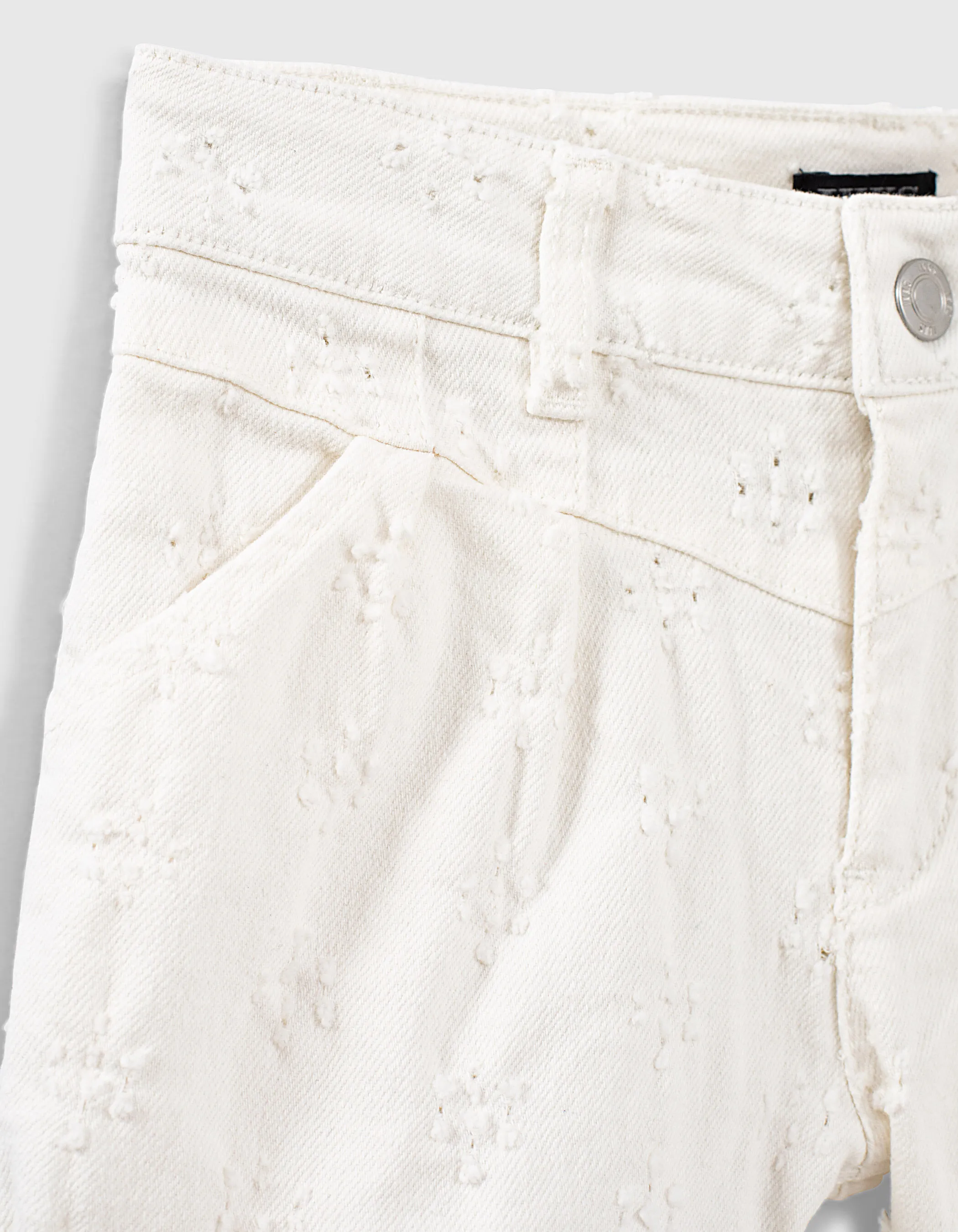 Broken white denim shorts with distressed details for girls.