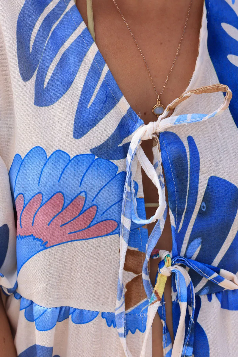 Cream tie-up top with blue watercolor palm leaves and parrots print.